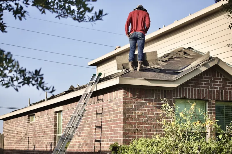 Professional roofer working on a residential roof in Baldwin Mill Terrace